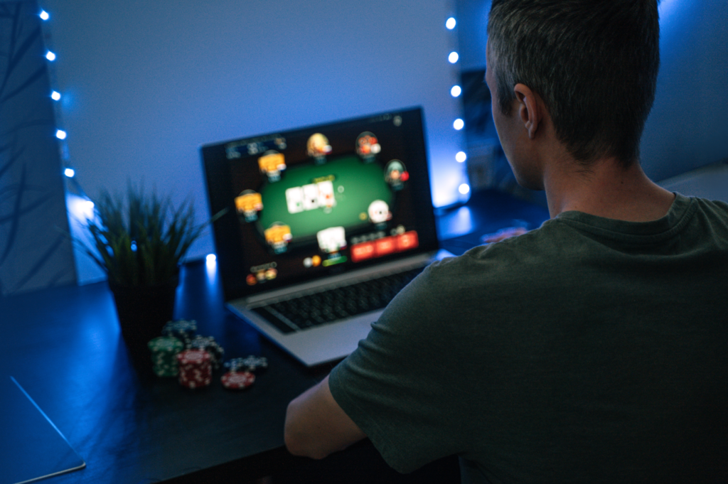 Man at computer screen with poker
