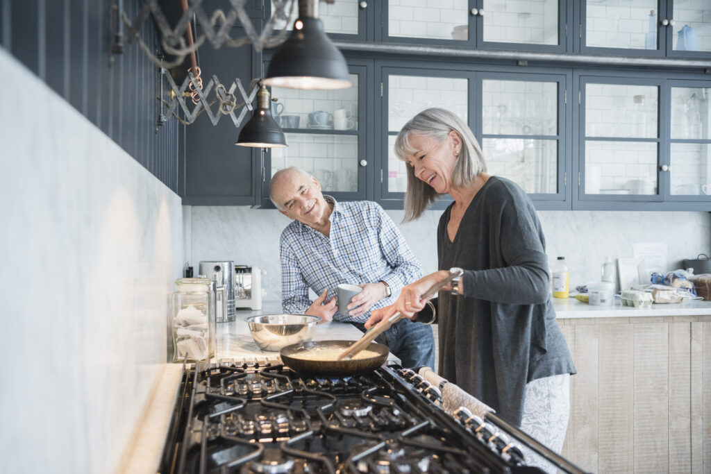Older couple cooking.