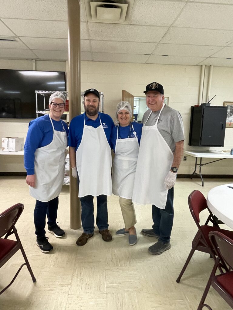 CFCU employees smiling while volunteering at Motown Soup